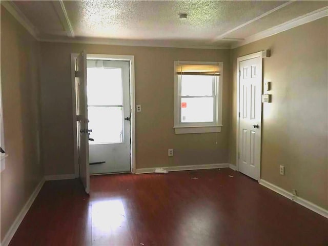18989 Washtenaw St, Harper Woods, MI 48225 - foyer entrance featuring a textured ceiling, baseboards, wood finished floors, and ornamental molding