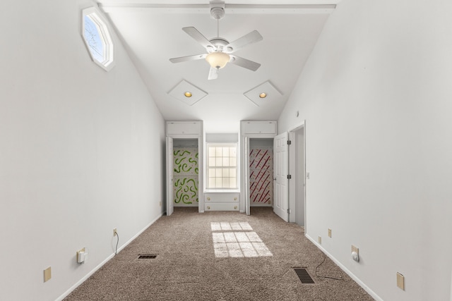 unfurnished bedroom with multiple windows, carpet flooring, high vaulted ceiling, and baseboards