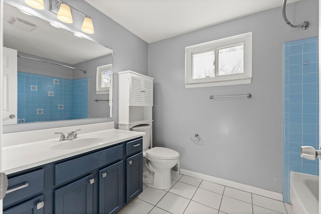 bathroom featuring tile patterned flooring, bathtub / shower combination, toilet, vanity, and baseboards