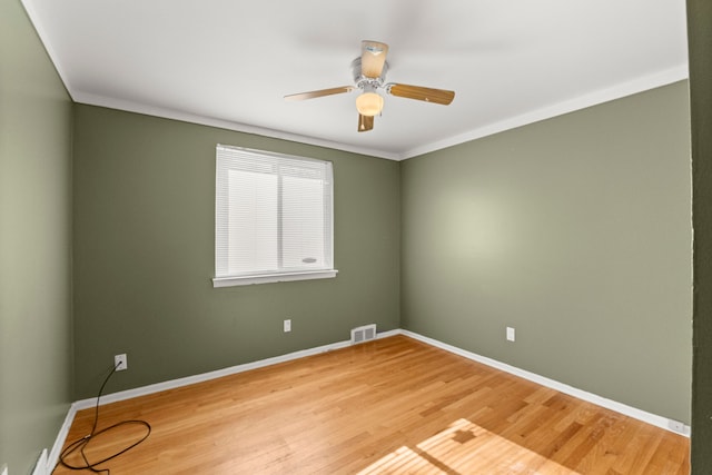 spare room featuring ceiling fan, baseboards, and light wood-type flooring