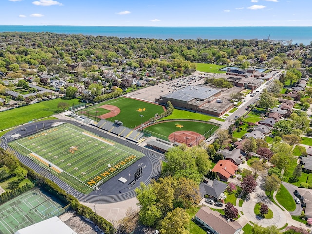 aerial perspective of suburban area with a nearby body of water