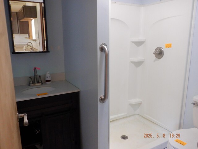 824 Gayle Ave, Kalamazoo, MI 49048 - bathroom with a stall shower, toilet, and vanity