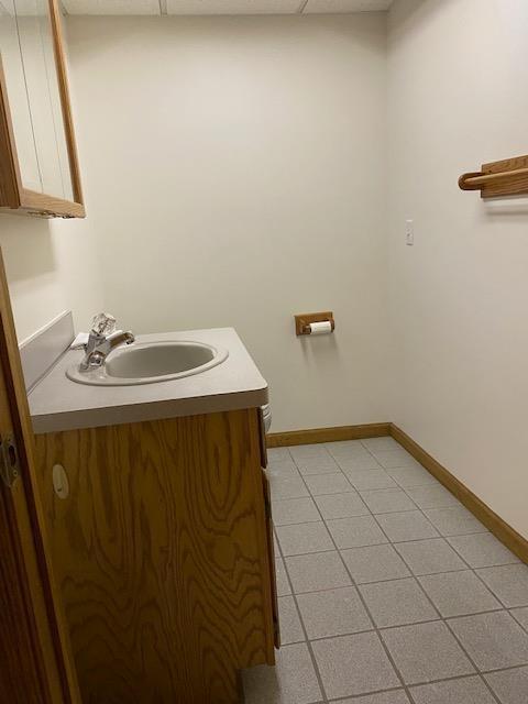 28379 Emerald Ct, Chesterfield, MI 48047 - half bath featuring vanity, tile patterned floors, baseboards, and toilet