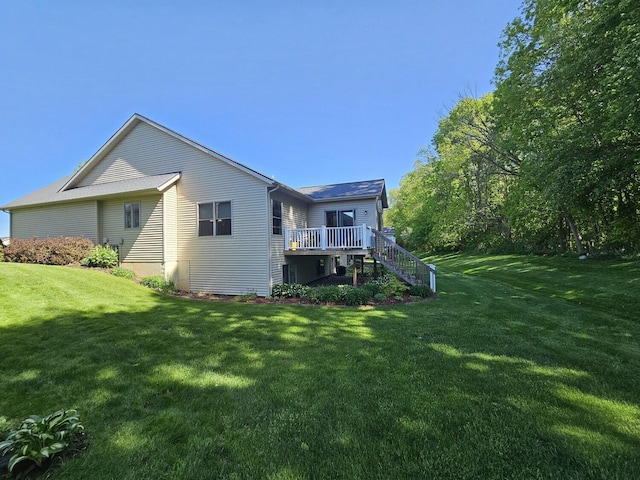 12250 Aleigha Dr NW, Grand Rapids, MI 49534 - back of house featuring stairway, a yard, and a wooden deck