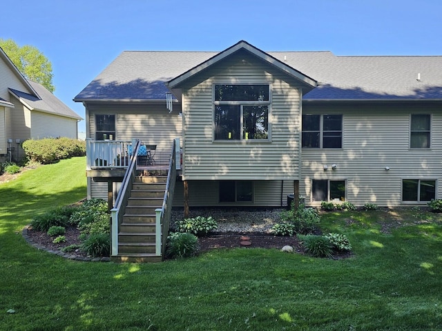 12250 Aleigha Dr NW, Grand Rapids, MI 49534 - rear view of property featuring stairs, a lawn, and a deck