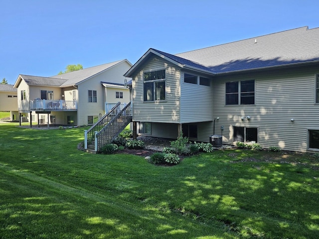 12250 Aleigha Dr NW, Grand Rapids, MI 49534 - rear view of property with stairs, a yard, and central air condition unit