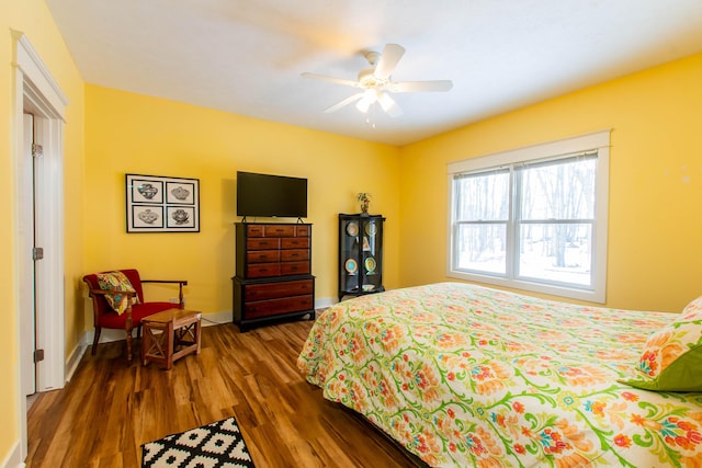 12250 Aleigha Dr NW, Grand Rapids, MI 49534 - bedroom with dark wood-type flooring, baseboards, and a ceiling fan
