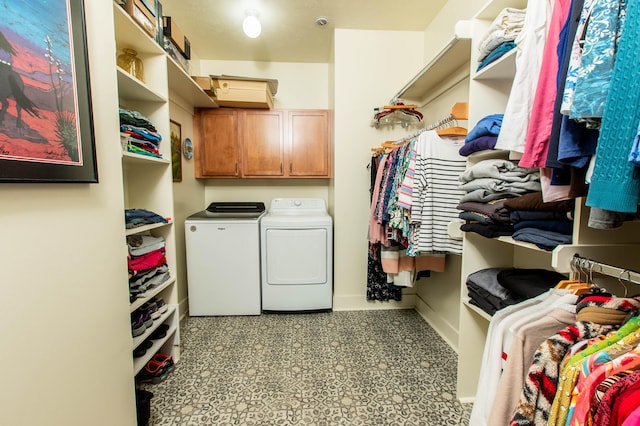 12250 Aleigha Dr NW, Grand Rapids, MI 49534 - laundry area featuring washer and dryer, cabinet space, and baseboards