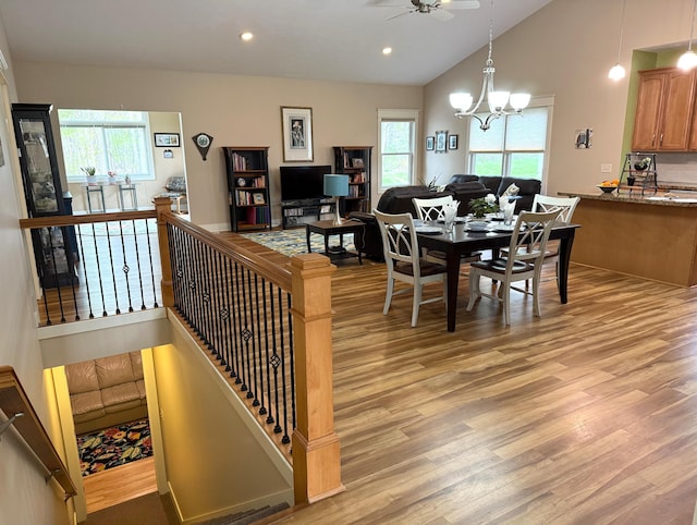 12250 Aleigha Dr NW, Grand Rapids, MI 49534 - dining area featuring light wood-style floors, ceiling fan, a chandelier, recessed lighting, and vaulted ceiling