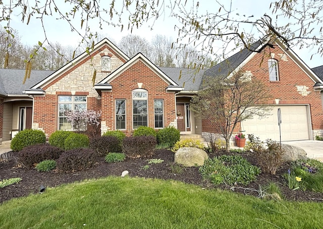12250 Aleigha Dr NW, Grand Rapids, MI 49534 - view of front facade featuring concrete driveway, brick siding, stone siding, and a garage