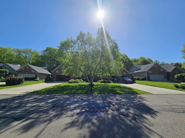 12250 Aleigha Dr NW, Grand Rapids, MI 49534 - obstructed view of property featuring concrete driveway, a residential view, and a garage