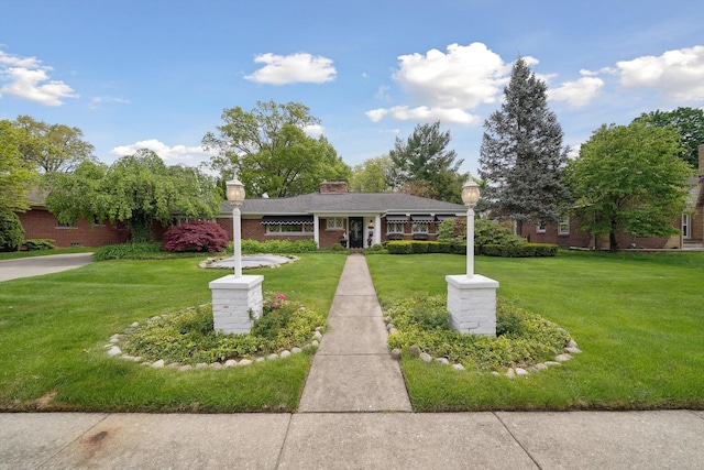 511 S Gulley Rd, Dearborn, MI 48124 - ranch-style home featuring a front yard, brick siding, and a chimney