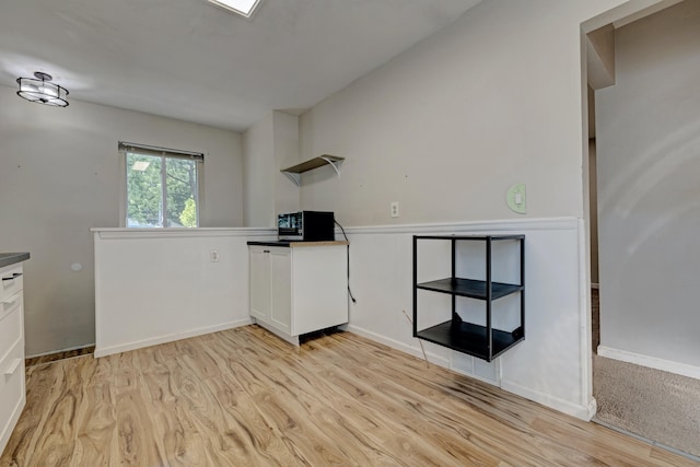 19526 Broadacres St, Clinton Township, MI 48035 - kitchen with open shelves, light wood finished floors, white cabinetry, black microwave, and dark countertops