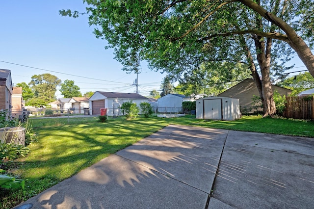19526 Broadacres St, Clinton Township, MI 48035 - view of yard featuring a storage unit, a garage, and a patio