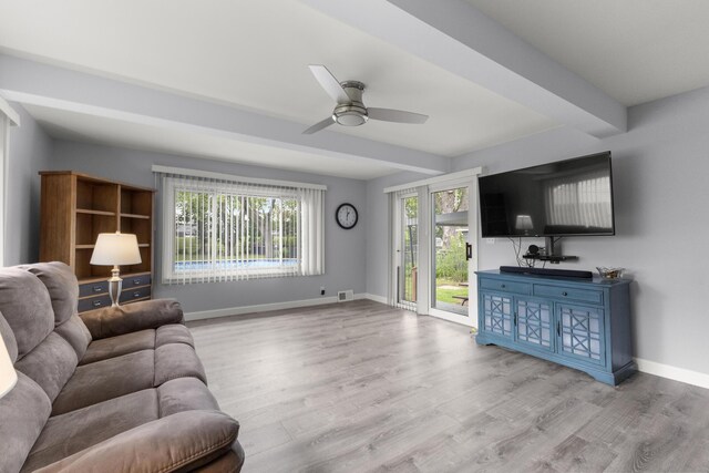 12550 Devoe St, Southgate, MI 48195 - living room featuring a ceiling fan, wood finished floors, baseboards, and beamed ceiling