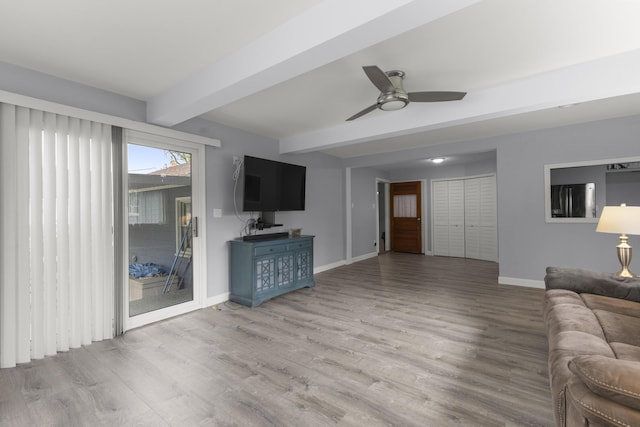 12550 Devoe St, Southgate, MI 48195 - unfurnished living room featuring beam ceiling, wood finished floors, baseboards, and a ceiling fan