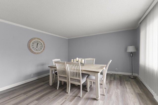 12550 Devoe St, Southgate, MI 48195 - dining room with wood finished floors, baseboards, ornamental molding, and a textured ceiling
