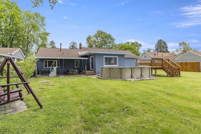 12550 Devoe St, Southgate, MI 48195 - back of house featuring an outdoor pool, stairway, a chimney, a lawn, and a wooden deck