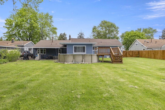 12550 Devoe St, Southgate, MI 48195 - rear view of property featuring a deck, an outdoor pool, and a chimney
