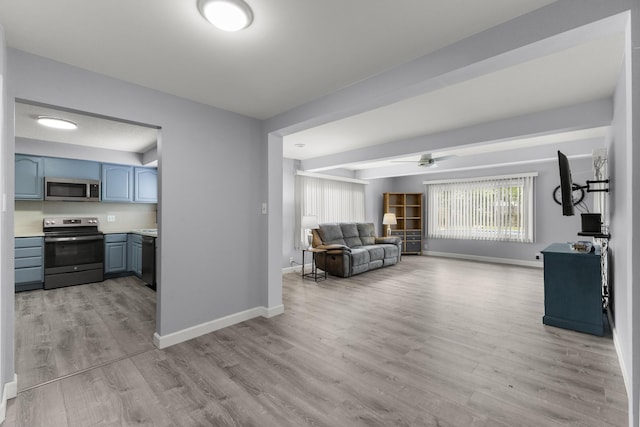 12550 Devoe St, Southgate, MI 48195 - living room featuring light wood-type flooring, baseboards, and ceiling fan