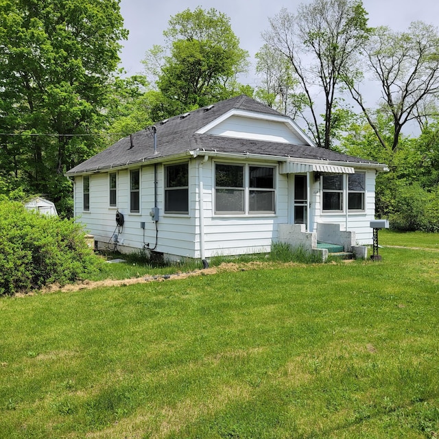 1614 Mooreville Rd, Milan, MI 48160 - back of house with a lawn and roof with shingles