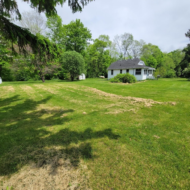 1614 Mooreville Rd, Milan, MI 48160 - view of green lawn featuring a storage unit and an outdoor structure