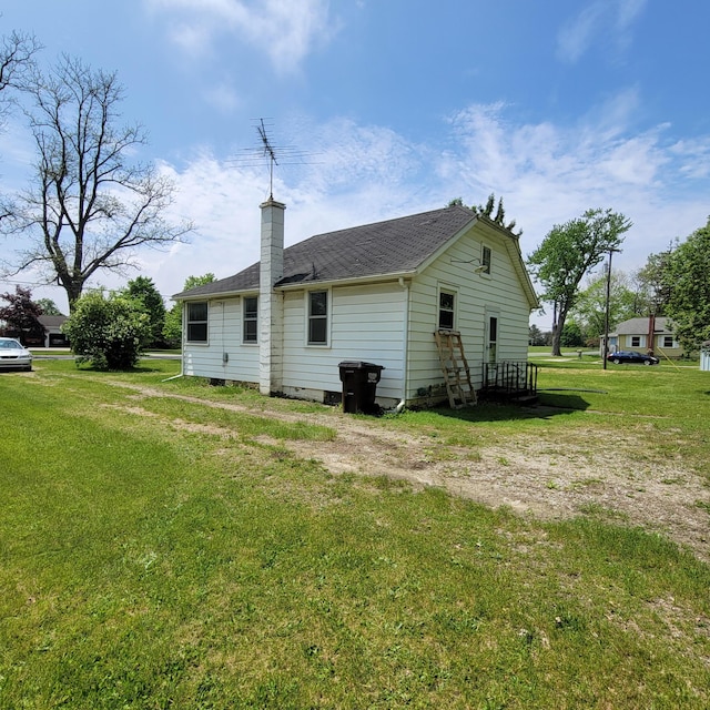 1614 Mooreville Rd, Milan, MI 48160 - back of property with a yard, a chimney, and a shingled roof