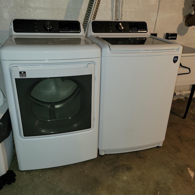 1614 Mooreville Rd, Milan, MI 48160 - clothes washing area featuring washer and clothes dryer and concrete block wall