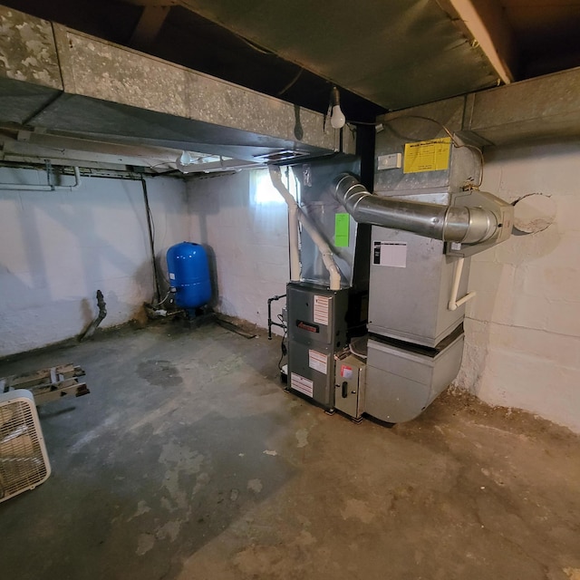 1614 Mooreville Rd, Milan, MI 48160 - unfinished basement featuring a water pressure tank and heating unit