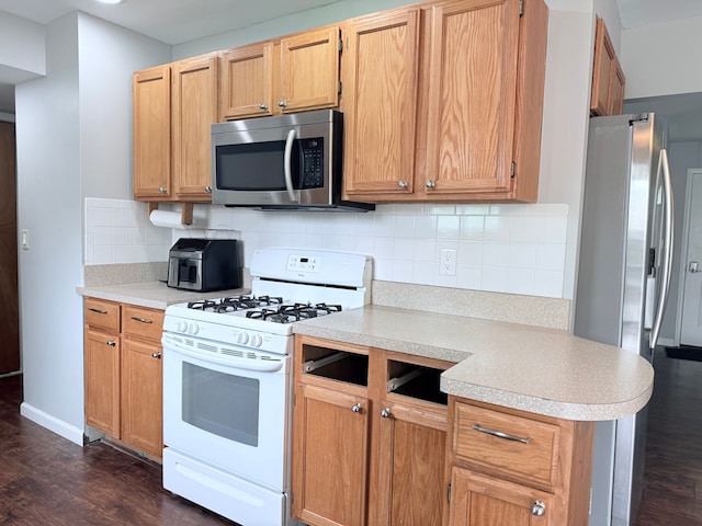 1666 Kile Rd, Metamora, MI 48455 - kitchen featuring stainless steel microwave, white range with gas stovetop, light countertops, and dark wood-style floors