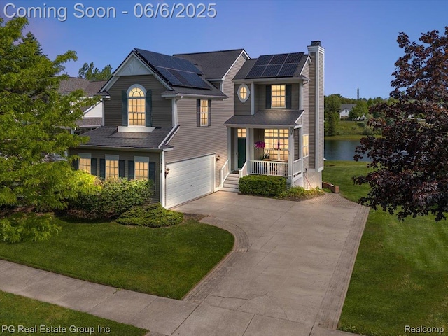 1226 Fountain View Ln, Oxford, MI 48371 - view of front of home with covered porch, driveway, a front lawn, a chimney, and a garage