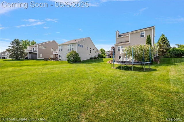 1226 Fountain View Ln, Oxford, MI 48371 - view of green lawn featuring a trampoline and a residential view