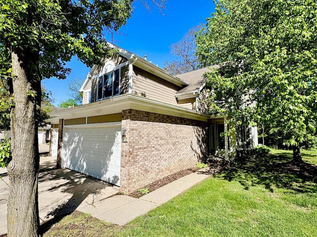 2423 Mulberry Ct, Ann Arbor, MI 48104 - view of side of home featuring brick siding, a garage, a yard, and concrete driveway
