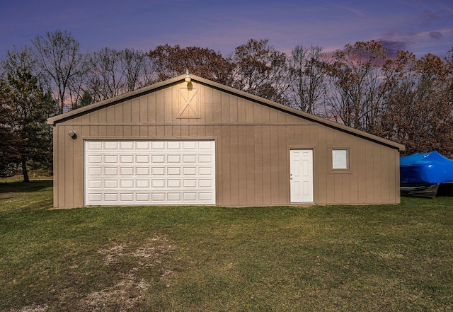 11400 Hillman, Davisburg, MI 48350 - garage at dusk featuring a garage and a yard