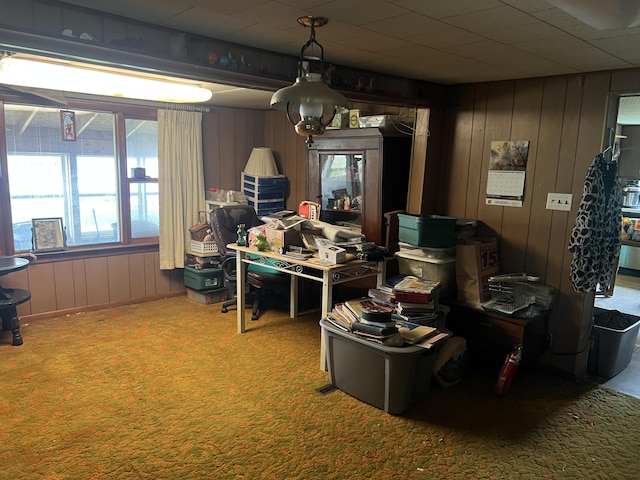 office area featuring carpet and wooden walls