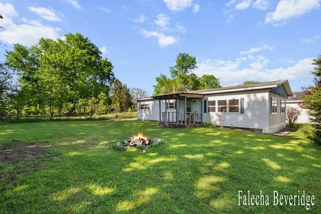 914 32nd St, Allegan, MI 49010 - back of property featuring an outdoor fire pit and a yard