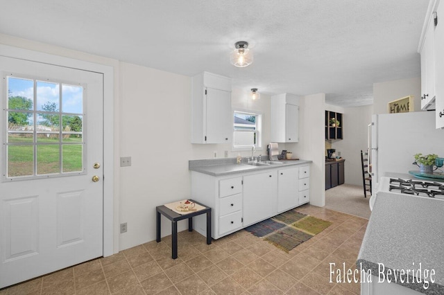 914 32nd St, Allegan, MI 49010 - kitchen with plenty of natural light, light countertops, and white cabinetry