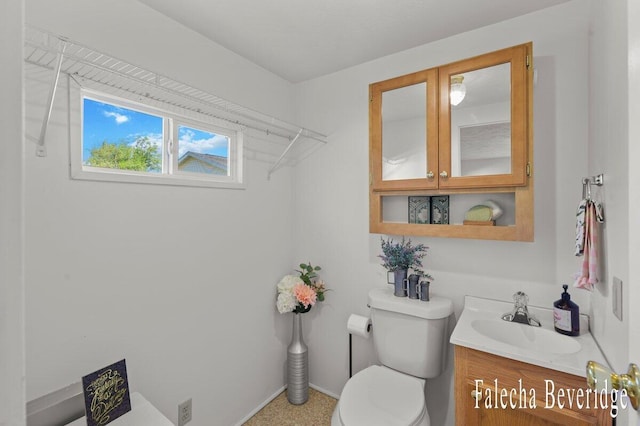 914 32nd St, Allegan, MI 49010 - bathroom with toilet, vanity, and baseboards