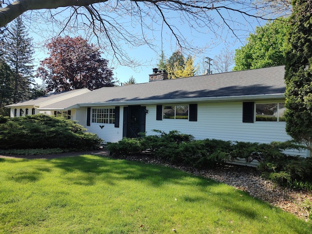 109 Cornell St, Howell, MI 48843 - ranch-style home with a front yard and a chimney