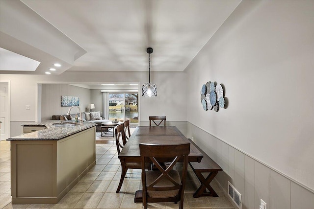 53383 Starlite Dr, Michigan, MI 48316 - dining room featuring light tile patterned flooring, a decorative wall, wainscoting, and recessed lighting