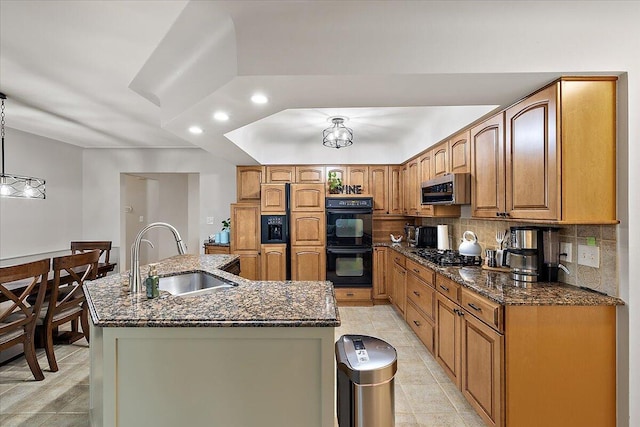 53383 Starlite Dr, Michigan, MI 48316 - kitchen featuring a sink, black appliances, an island with sink, tasteful backsplash, and dark stone counters