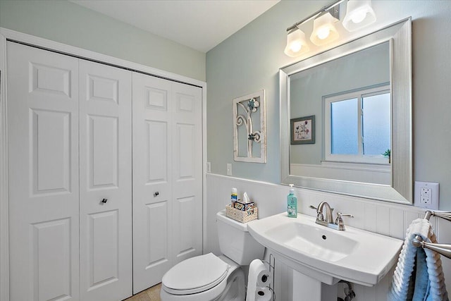 53383 Starlite Dr, Michigan, MI 48316 - bathroom featuring a closet, a wainscoted wall, toilet, and a sink
