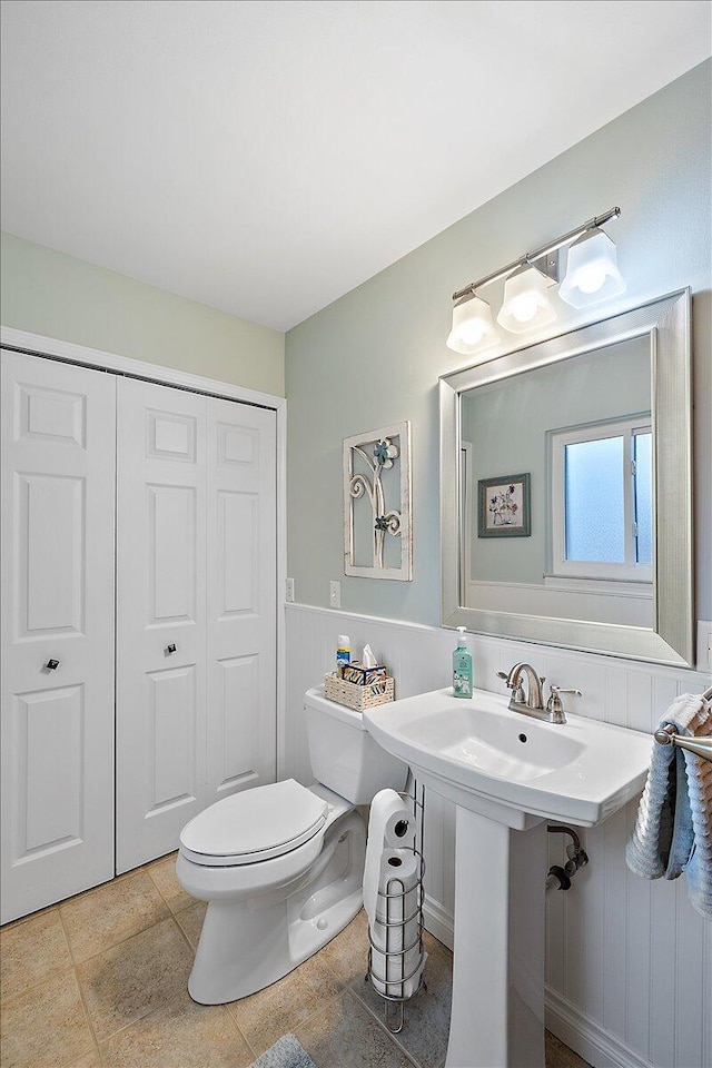 53383 Starlite Dr, Michigan, MI 48316 - half bathroom with toilet, wainscoting, and tile patterned flooring
