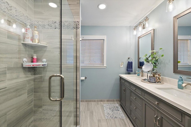 53383 Starlite Dr, Michigan, MI 48316 - bathroom featuring a stall shower, double vanity, baseboards, and recessed lighting
