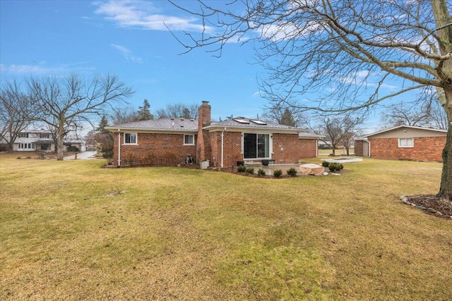 53383 Starlite Dr, Michigan, MI 48316 - rear view of property featuring brick siding, a chimney, and a yard