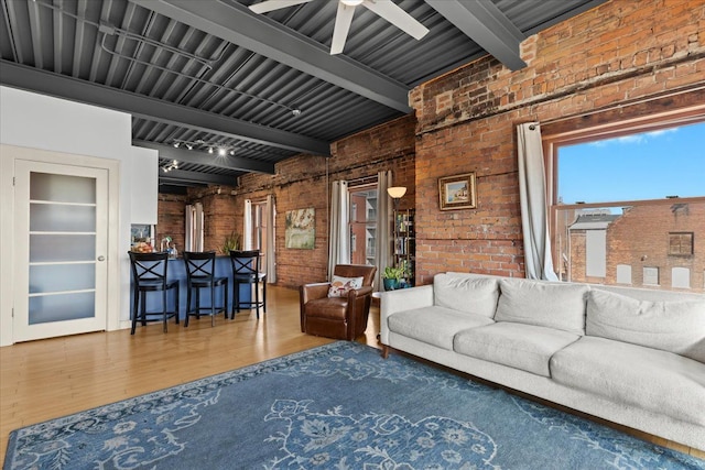 112 Watson St Unit 28, Detroit, MI 48201 - living room featuring wood finished floors, brick wall, beamed ceiling, and a ceiling fan