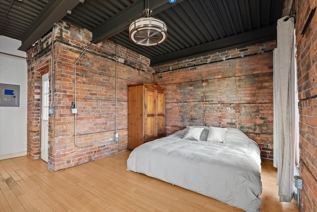 112 Watson St Unit 28, Detroit, MI 48201 - bedroom with brick wall, wood finished floors, electric panel, and baseboards
