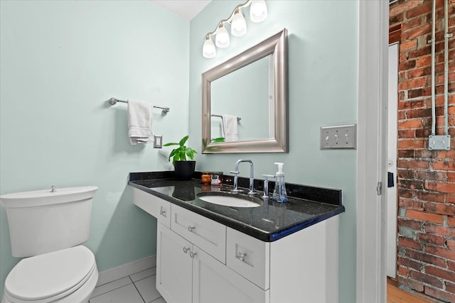 112 Watson St Unit 28, Detroit, MI 48201 - bathroom featuring toilet, vanity, tile patterned flooring, and baseboards