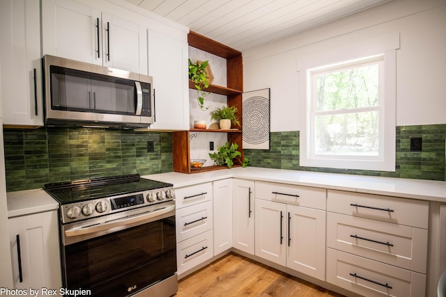 2490 S Parsons Ave, Fremont, MI 49412 - kitchen with stainless steel appliances, open shelves, light countertops, white cabinets, and wooden ceiling
