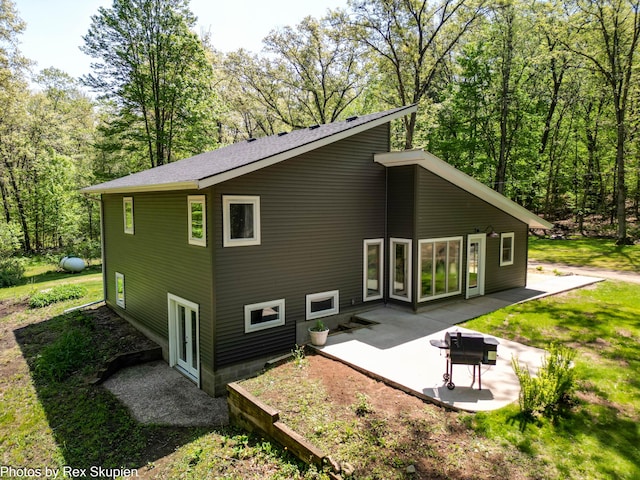 2490 S Parsons Ave, Fremont, MI 49412 - back of house with a patio area and a wooded view